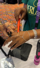 Load image into Gallery viewer, Client adding a hand chain at the PJ Expo in San Antonio